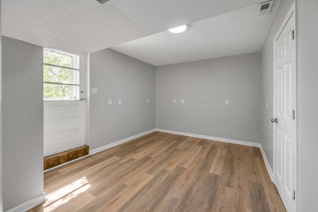 interior space featuring hardwood / wood-style flooring and a textured ceiling