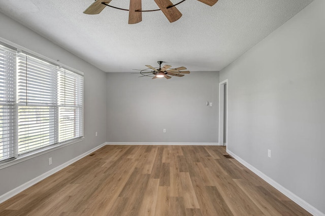 unfurnished room with ceiling fan, hardwood / wood-style flooring, and plenty of natural light