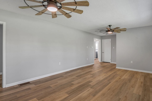 spare room featuring wood-type flooring and ceiling fan