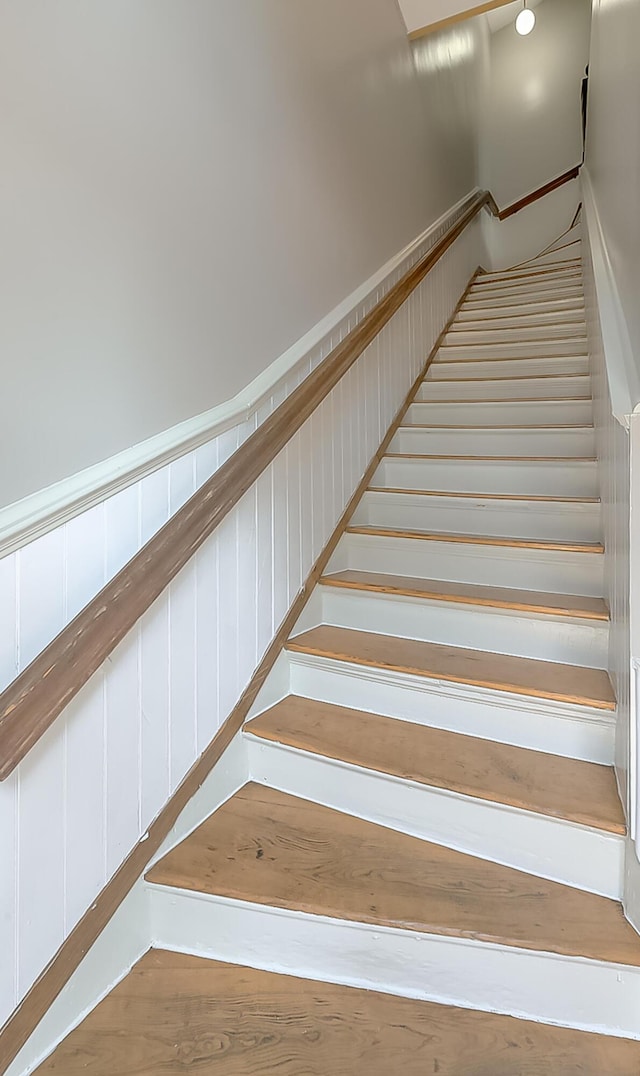 stairs featuring wood-type flooring