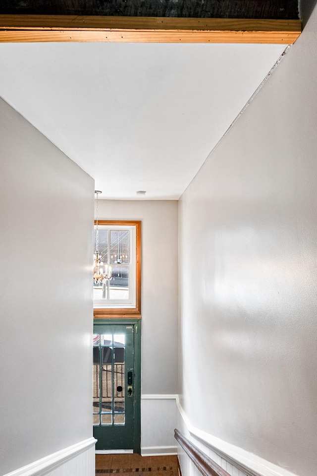 unfurnished room featuring a notable chandelier and a healthy amount of sunlight