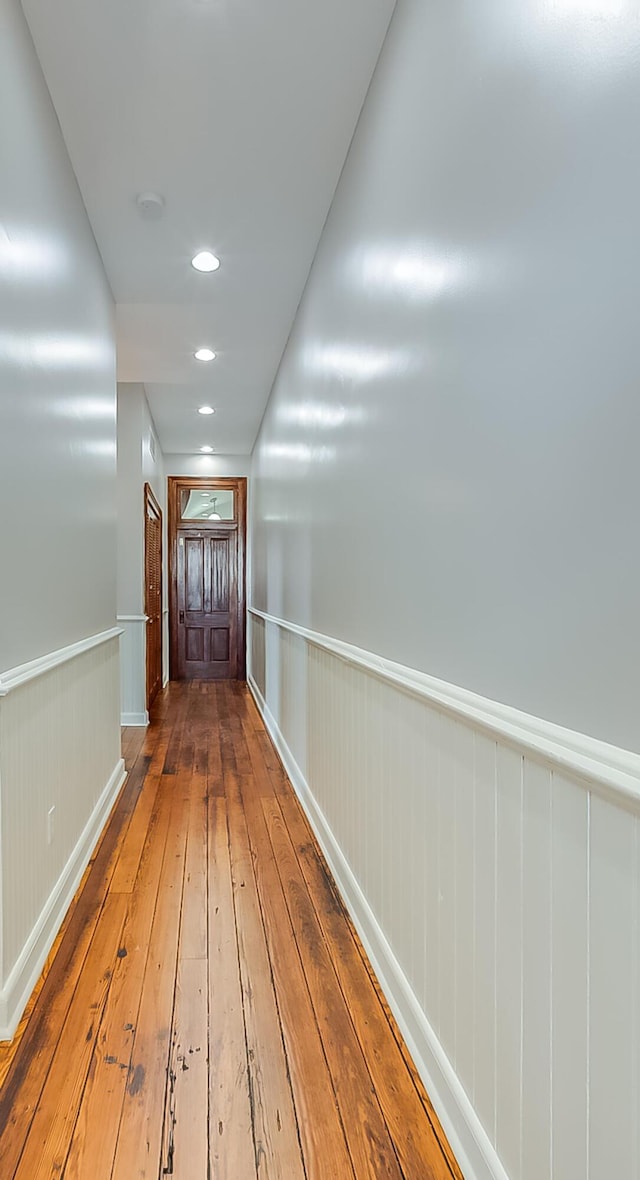 corridor with hardwood / wood-style floors