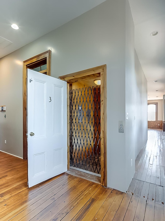 hall with wood-type flooring