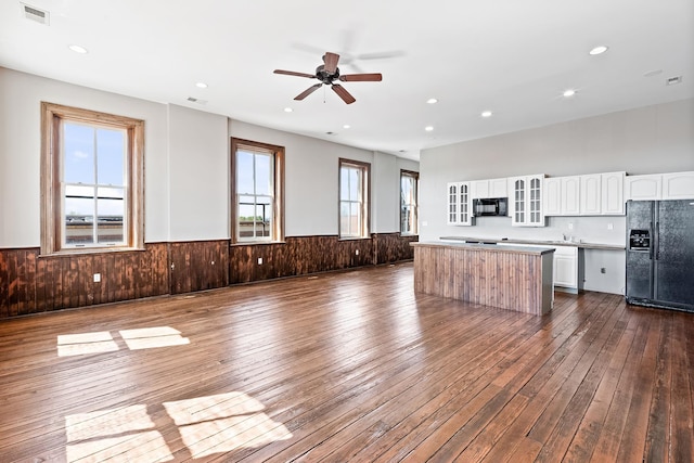 unfurnished living room featuring wood-type flooring and ceiling fan