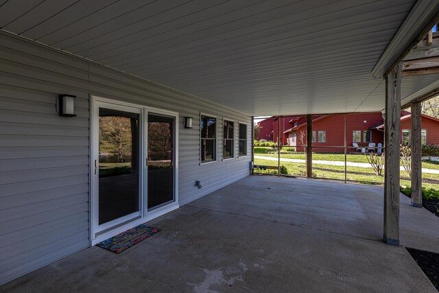 unfurnished sunroom with ceiling fan