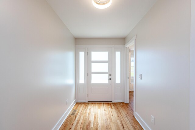 unfurnished sunroom featuring ceiling fan and a water view