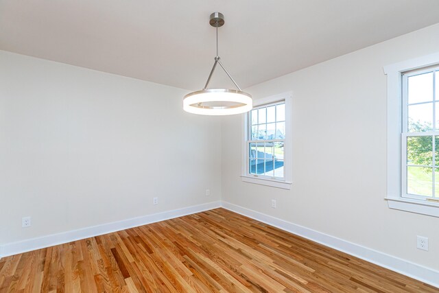 empty room with ceiling fan and light wood-type flooring