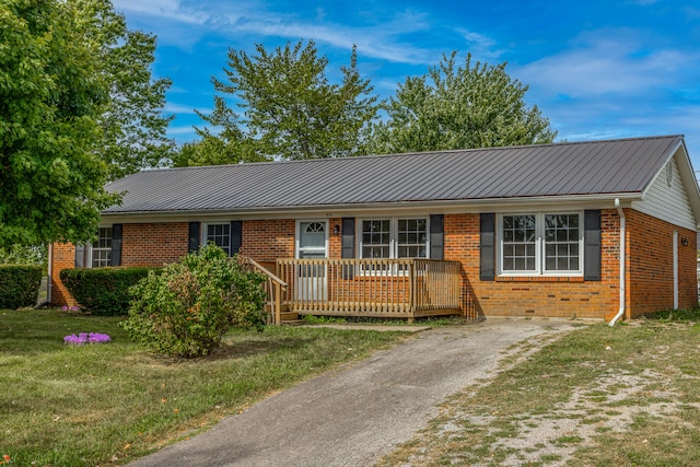 single story home featuring a wooden deck and a front lawn