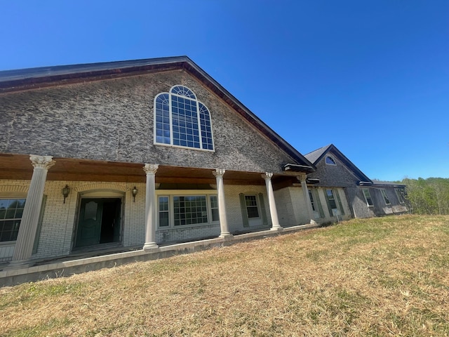 back of house with a lawn