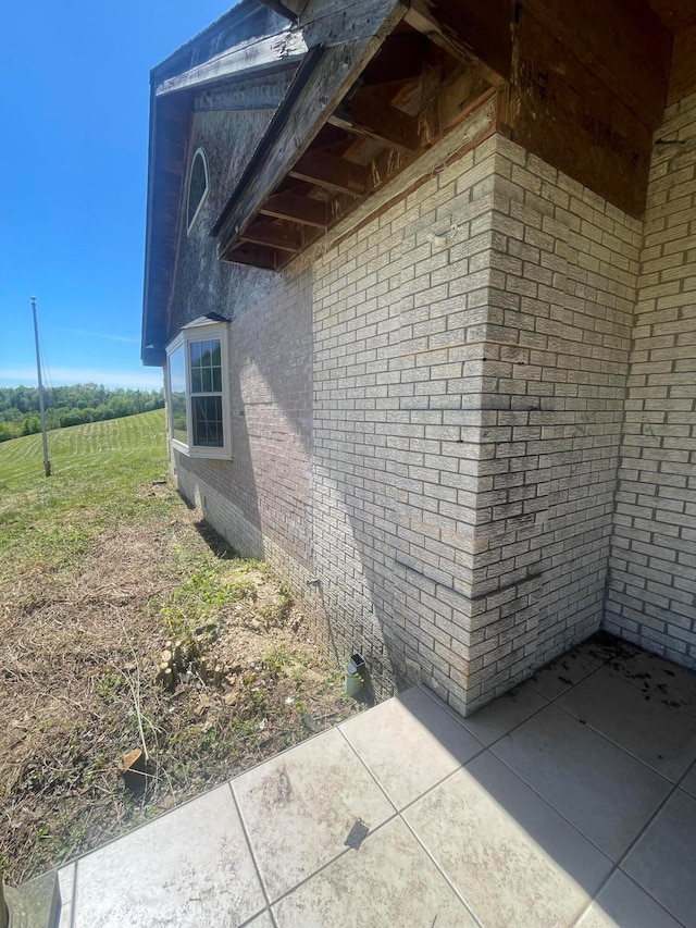 view of side of home with a patio area