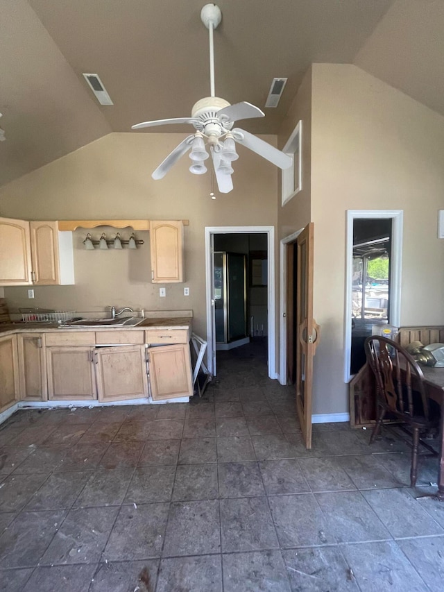 kitchen featuring light brown cabinetry, high vaulted ceiling, ceiling fan, and dark tile floors