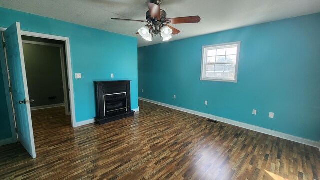 interior space featuring dark wood-type flooring and ceiling fan