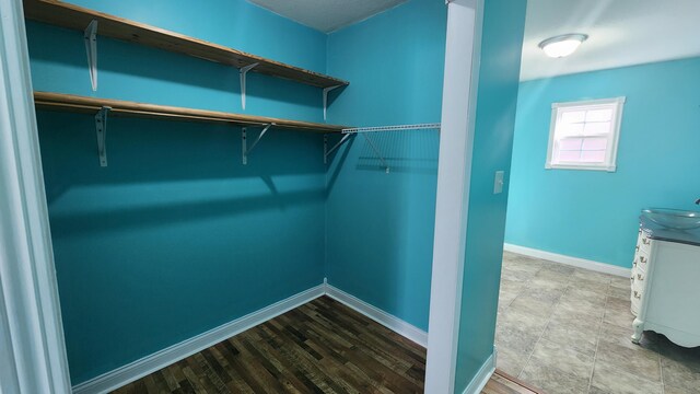 spacious closet featuring tile flooring