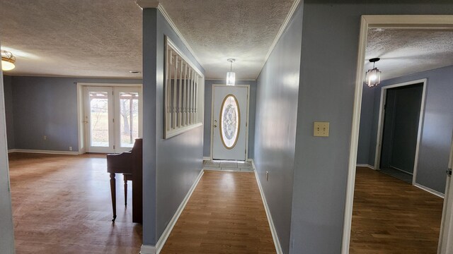 hall with wood-type flooring and a textured ceiling