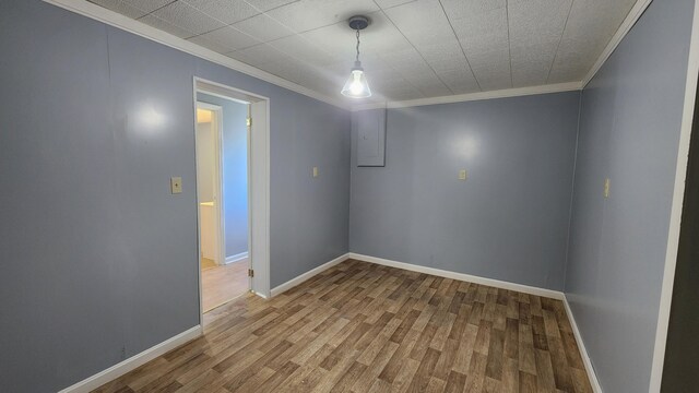 empty room with hardwood / wood-style floors and ornamental molding