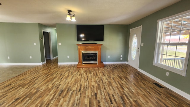 unfurnished living room featuring dark carpet