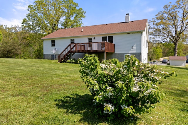 back of house featuring a wooden deck and a yard