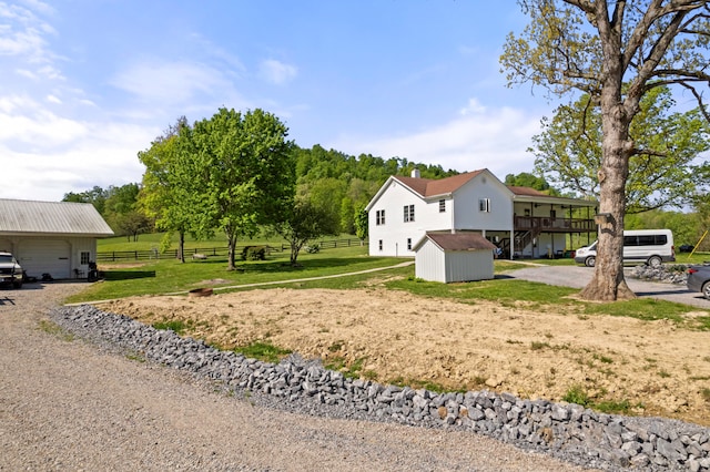 view of yard featuring a storage shed and a deck