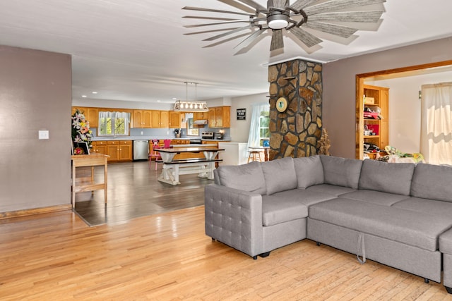 living room featuring light hardwood / wood-style floors, plenty of natural light, and ceiling fan