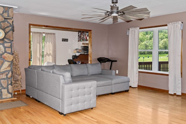 living room featuring ceiling fan and light wood-type flooring