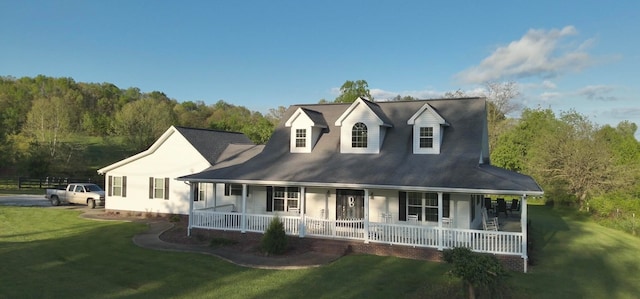 view of front of home featuring covered porch and a front lawn