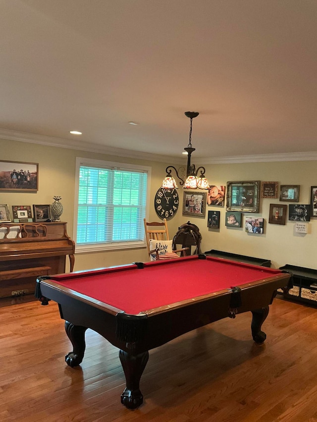 recreation room with ornamental molding, hardwood / wood-style floors, and pool table