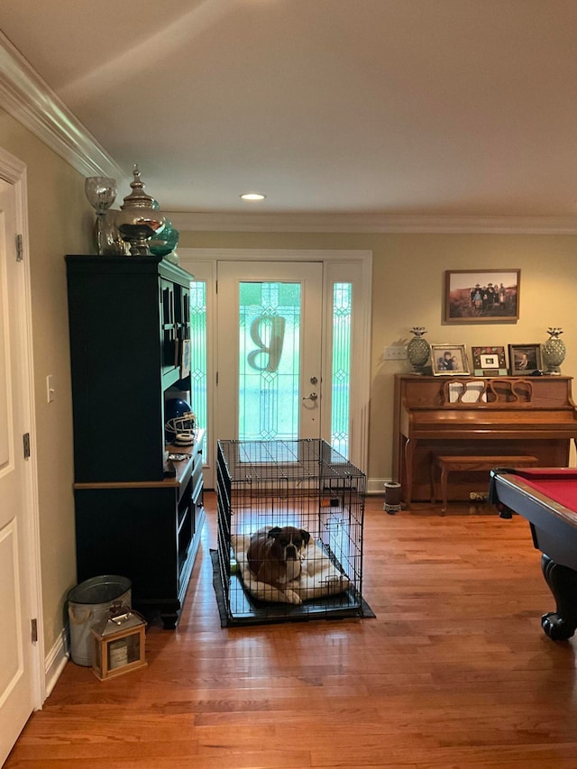 foyer featuring crown molding, hardwood / wood-style flooring, and billiards