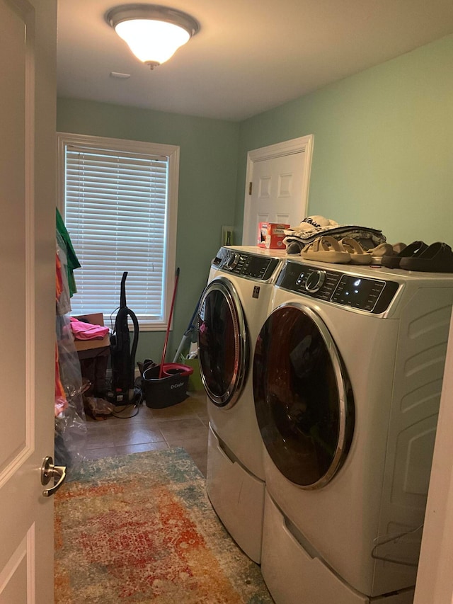 clothes washing area featuring tile patterned floors and washing machine and dryer