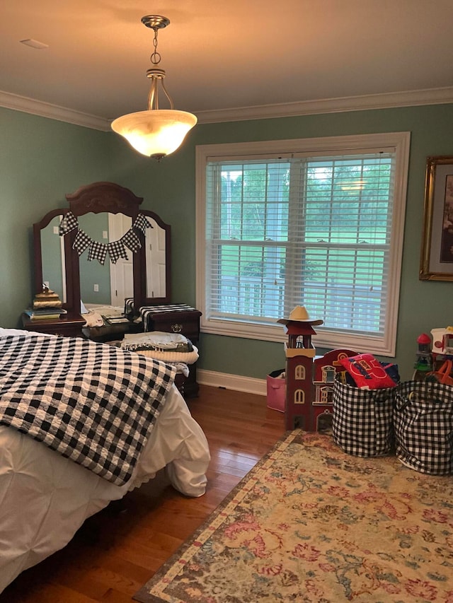 bedroom featuring hardwood / wood-style floors and crown molding