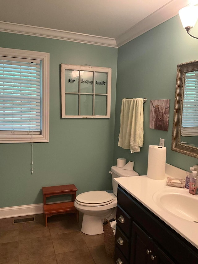 bathroom featuring toilet, crown molding, vanity, and tile patterned flooring