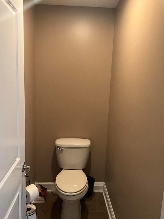 bathroom featuring toilet and tile patterned flooring