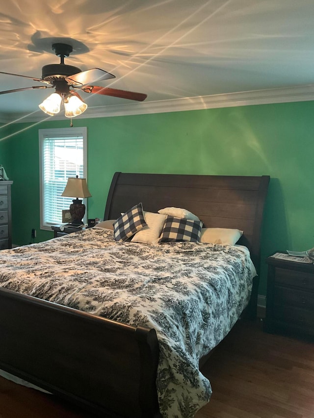 bedroom with ceiling fan, crown molding, and dark hardwood / wood-style flooring