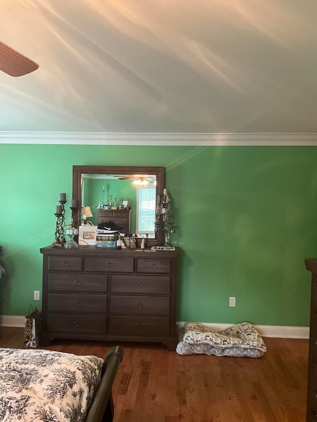 bedroom with crown molding and hardwood / wood-style flooring