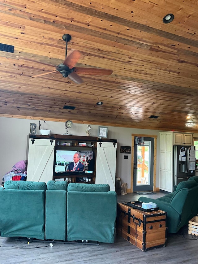 living room with wooden ceiling, ceiling fan, wood-type flooring, and a barn door