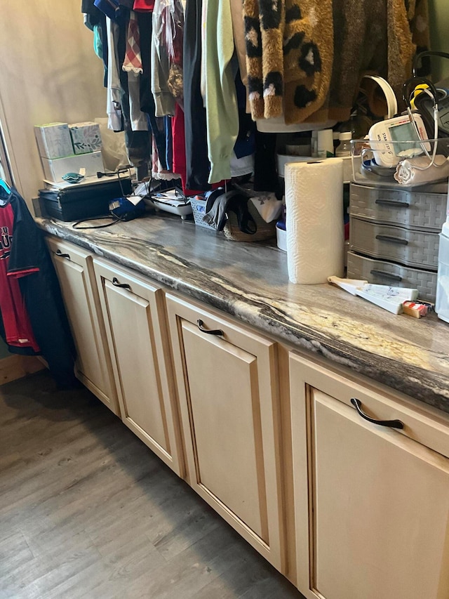 kitchen with dark stone counters and light hardwood / wood-style floors