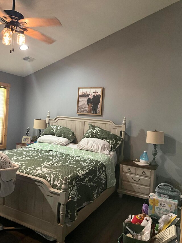 bedroom with ceiling fan and dark hardwood / wood-style floors