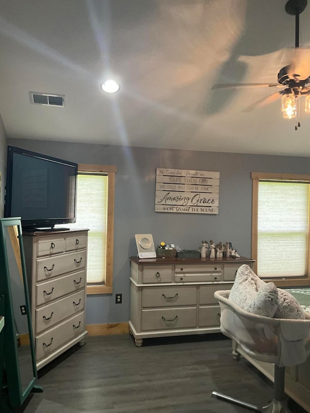 bedroom with dark wood-type flooring, multiple windows, and ceiling fan