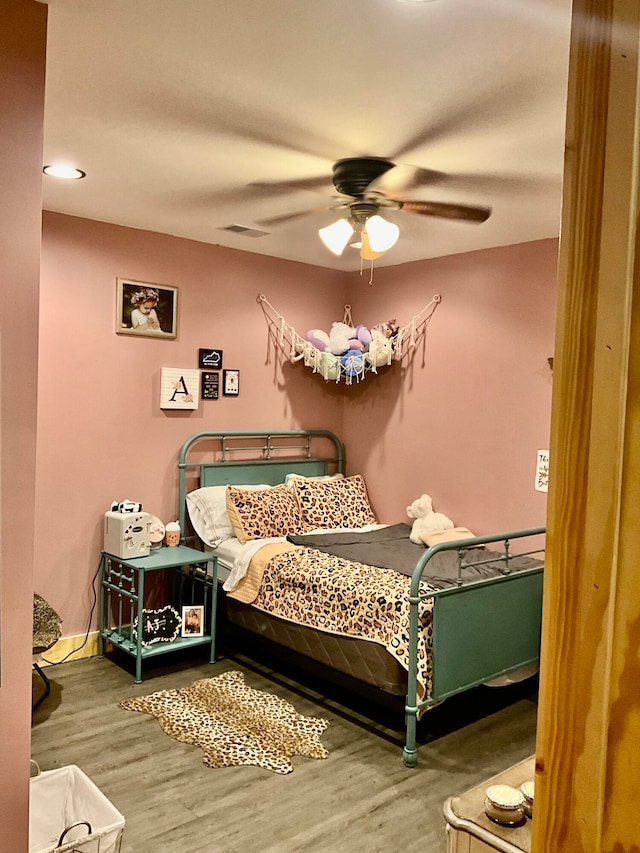 bedroom featuring hardwood / wood-style floors and ceiling fan