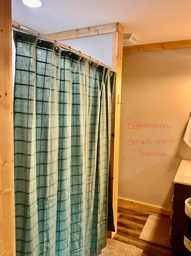 bathroom with hardwood / wood-style flooring and vanity