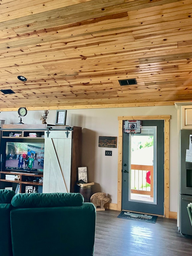 living room featuring a barn door, wooden ceiling, and hardwood / wood-style flooring