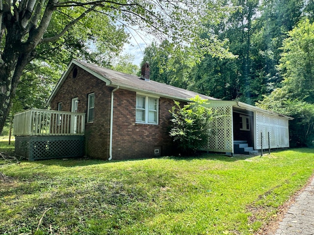 view of property exterior featuring a wooden deck and a lawn