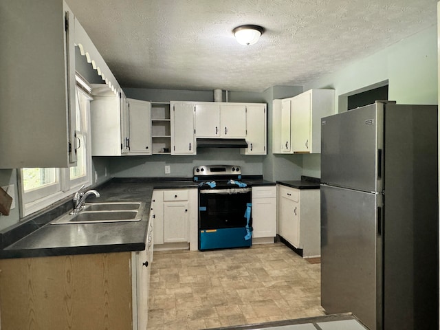 kitchen with a textured ceiling, stainless steel appliances, sink, and white cabinets