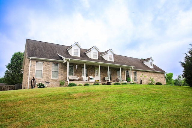 new england style home with central AC and a front yard