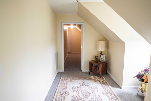 hallway with lofted ceiling and carpet floors