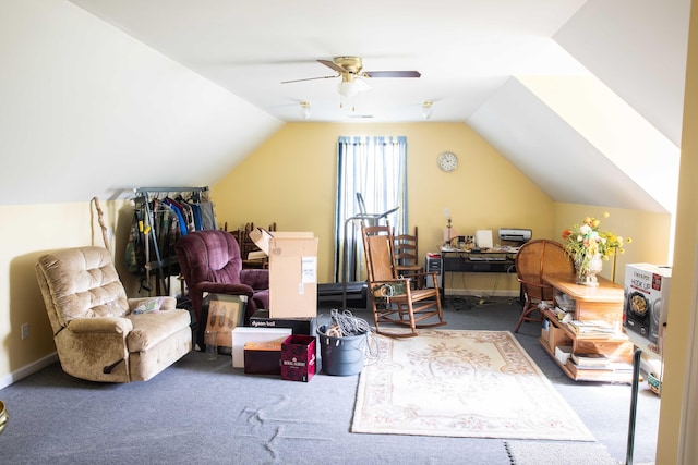 carpeted office space with ceiling fan and vaulted ceiling