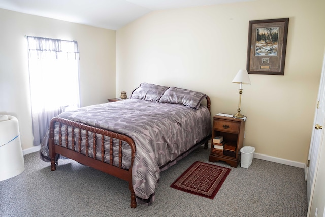 carpeted bedroom with lofted ceiling