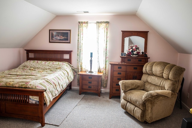 bedroom with carpet flooring and vaulted ceiling