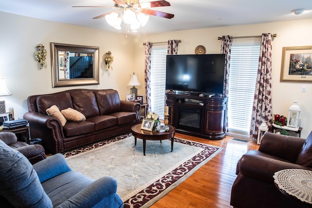 living room featuring hardwood / wood-style floors and ceiling fan