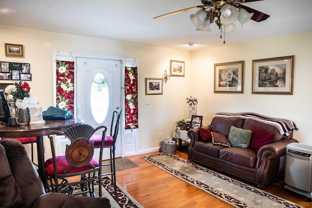 living room with wood-type flooring and ceiling fan