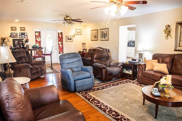 living room featuring wood-type flooring and ceiling fan